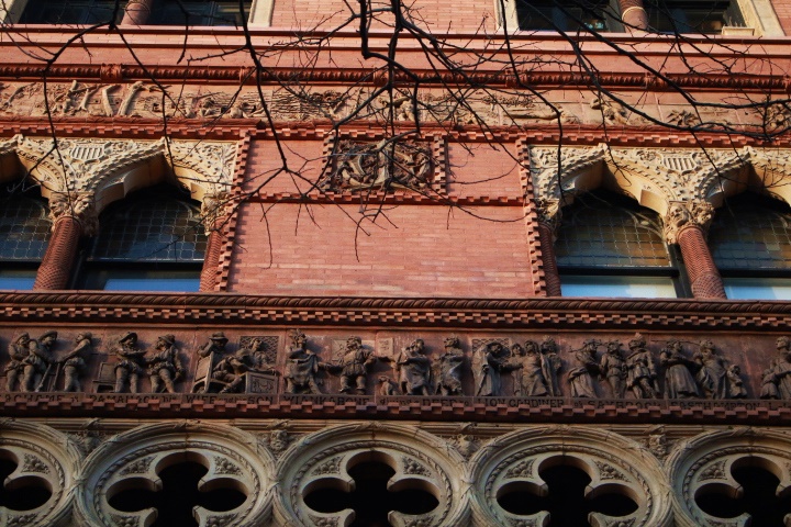 Quatrefoils, Venetian Gothic architecture and a relief sculpture facing South on the Montauk Club in Park Slope.