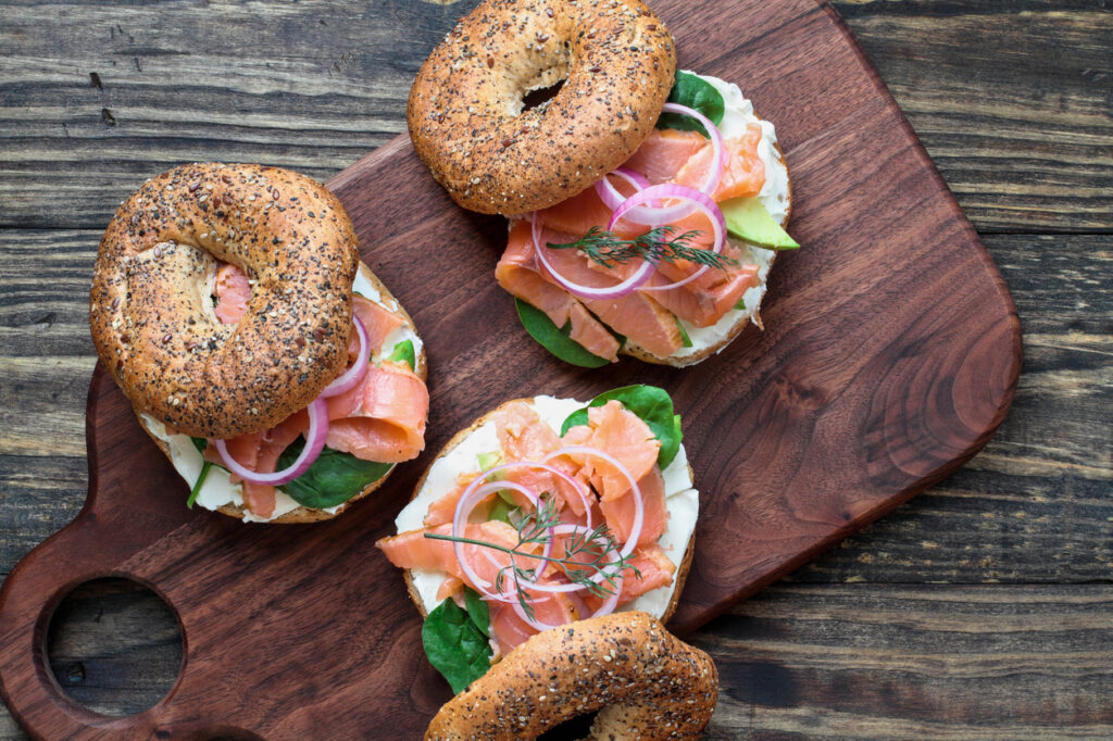 Three everything bagels topped with lox, cream cheese, red onion and dill. There are also less traditional toppings such as spinach and avocado.