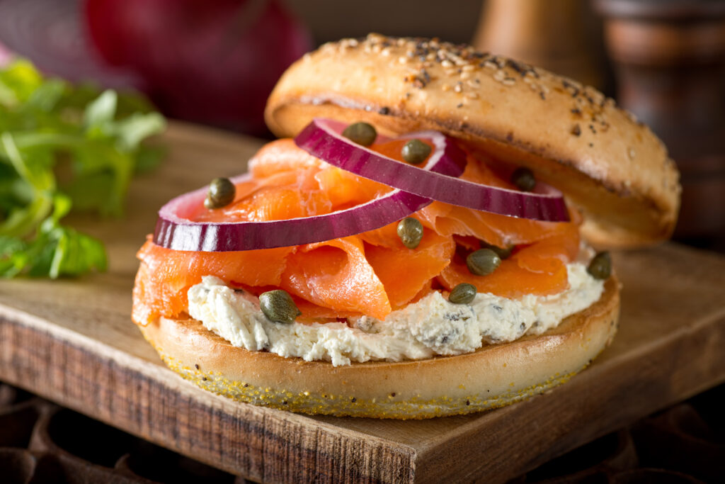 The history of the bagel is closely linked with Jewish people. A popular choice of topping for Jewish people is lox and schmear, or otherwise known as lox and cream cheese. This one is also topped with red onion and the less traditional capers.