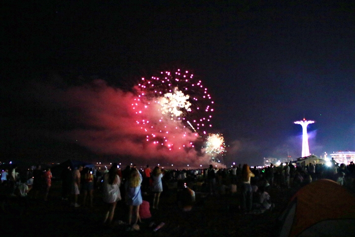 A photograph of people watching fireworks for Coney Island 4th of July.