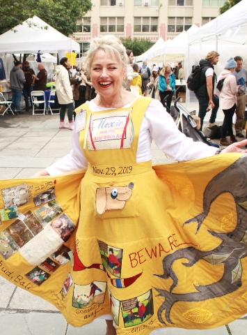 B. E. Exon shows off her homemade skirt and contributes to the Celebration of Literature with her book Moxie and the Kite Bite'n Ash.