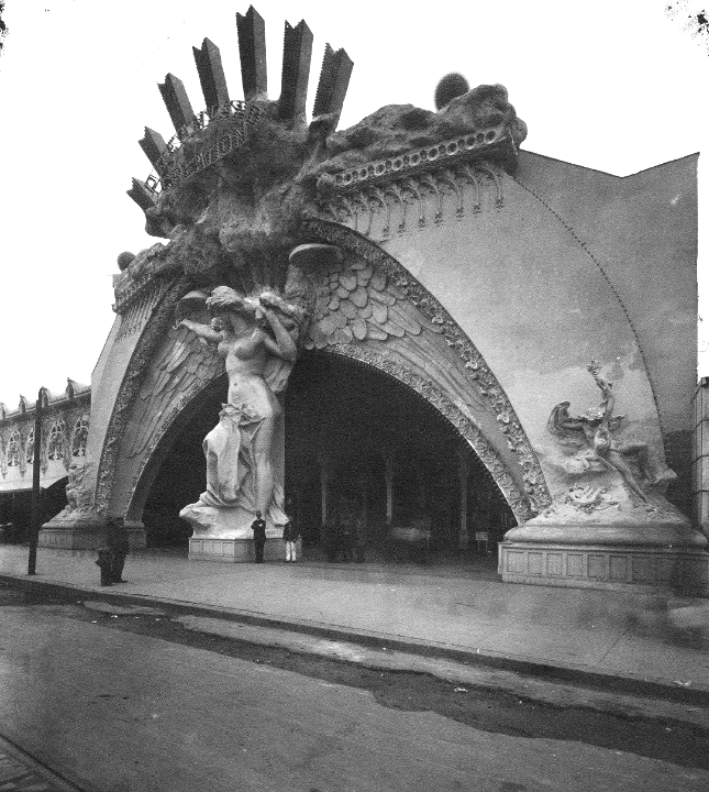 The grand entrance to one of Brooklyn's amusement parks, Dreamland. A Romanesque statue of an angel greets visitors, the wings forming the massive arches. 